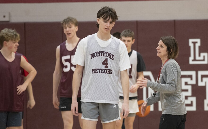 Montrose head coach Tracie McComb talks with senior Jude Adams during practice.