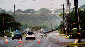 Downed power lines caused by Hurricane Lowell are seen across a road Tuesday, Sept. 8, 2026, in Hanapēpē, Kauaʻi, Hawaiʻi.