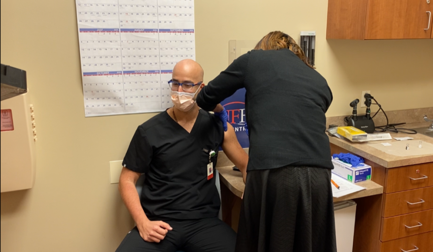 Pharmacist Erika Jasper administers the Pfizer/BioNTech vaccine to Dr. Elias Maroun. Photo: Joe Byrnes