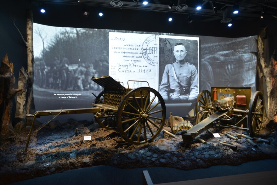 Harry Truman's photo is flashed on the screen with part of the World War I exhibit in the remodeled museum.