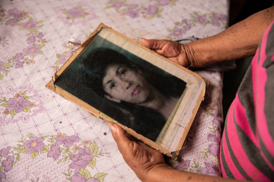 Edita Maldonado, mother of Rosa Lidia Pérez, holds a photograph of her once-disappeared daughter, whom she found with support from COFAMIPRO. Maldonado found her daughter and brought her home before she passed away in 2004.