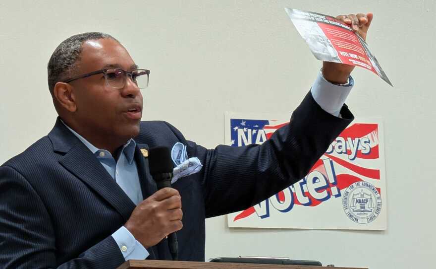 Charles Gates, incoming YJCW NAACP branch president, holds up a flier opposing the upcoming redistricting referendum that he received in the mail on Monday, April 13, 2026.