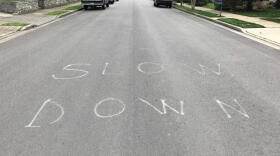 Some neighborhood vigilantes have been trying to slow traffic in whatever ways they can — like painting "slow down" in the street. (John Buntin/WPLN)