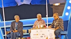 Tamil writer Perumal Murugan (center) conversed with his moderator at the Kolkata Literary Meet via an interpreter.