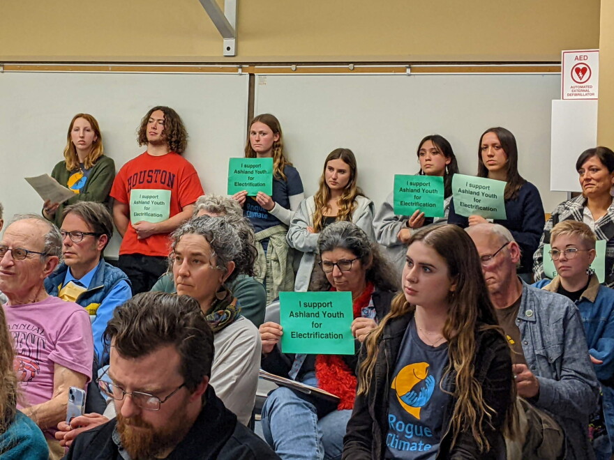  Members of the Rogue Climate Action Team hold signs in support of a proposed electrification ordinance in Ashland, March 21, 2023