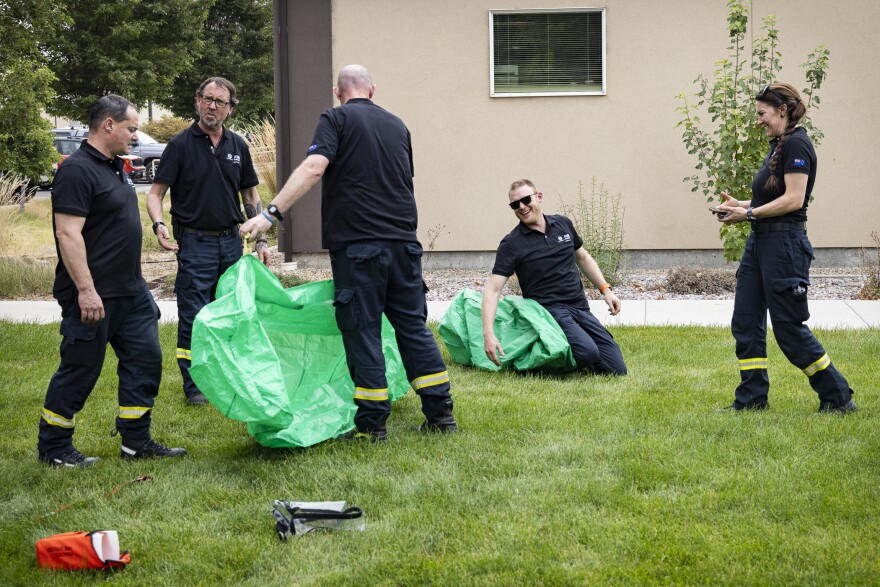 Firefighters train with practice fire shelters