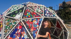 Adrienne Outlaw works on her ArtPrize installation, "The Grand Dome," outside the Eberhard Center