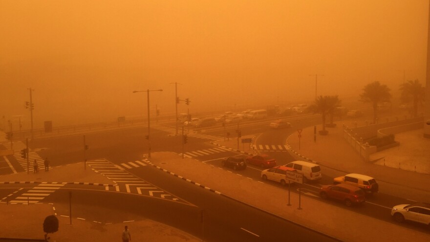 Cars are seen driving Thursday amid a sandstorm that engulfed the city of Dubai, United Arab Emirates.