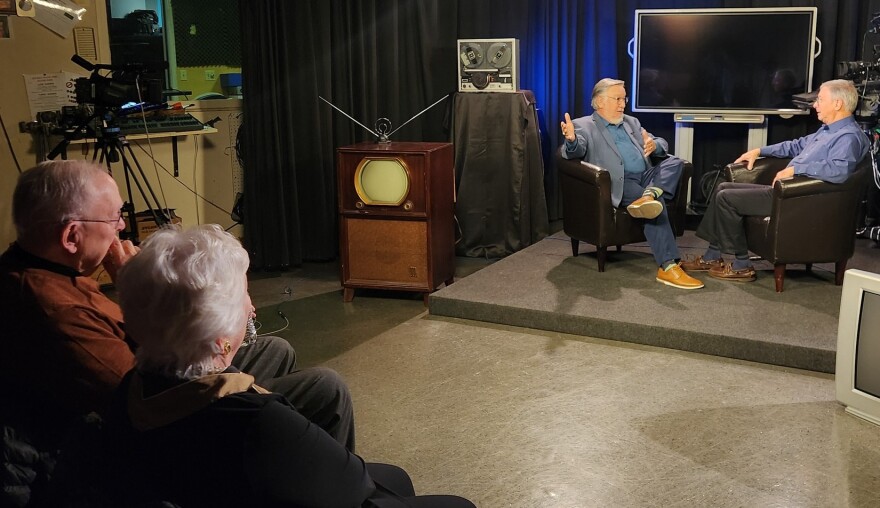 Colleen Sharp and Dick Murgatroyd watch as Rob Reider tapes his interview.