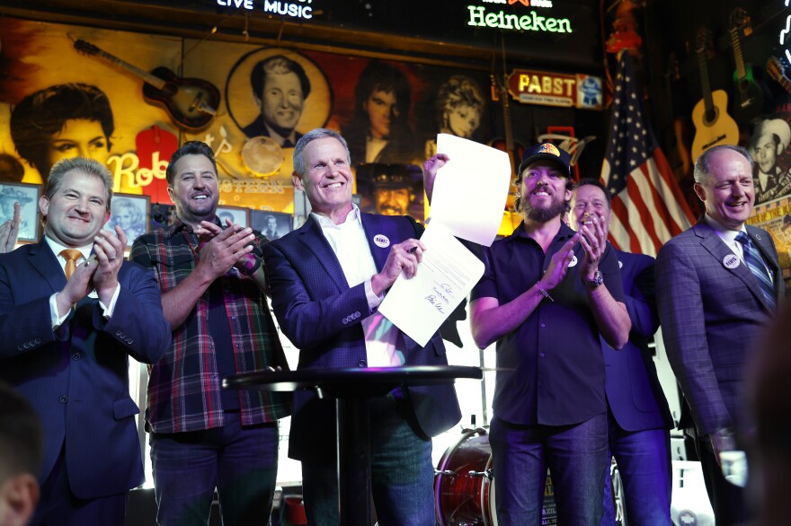 Lawmakers and supporters pose at the signing of the ELVIS Act at Robert's Western World in Nashville on March 21, 2024. Left to right: Representative William Lamberth, musician Luke Bryan, Governor Bill Lee, musician Chris Janson, RIAA head Mitch Glazier and Senator Jack Johnson.