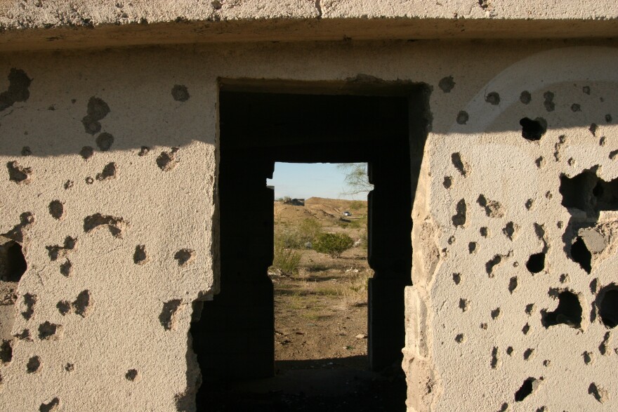Bullet holes pockmark the walls of an abandoned tienda near Manuel Benavides, Chihuahua, Mexico.
