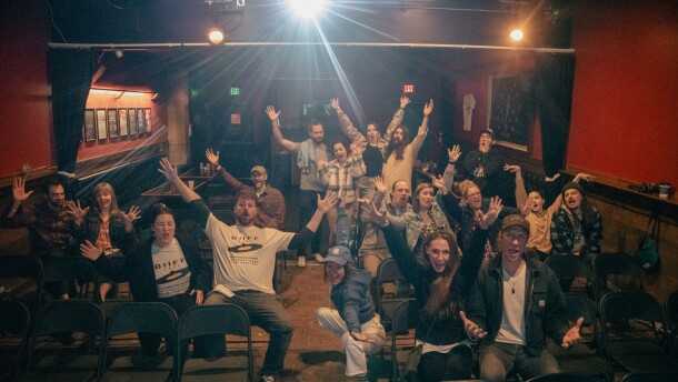 attendees at a film screening pose for a photo.