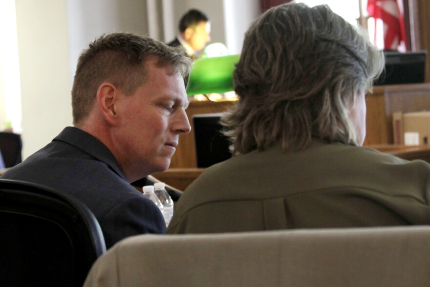 Chris Godfrey confers with an attorney in Polk County courtroom. After leaving his position as Iowa Workers' Compensation Commissioner, Godfrey took a similar position at the federal level.