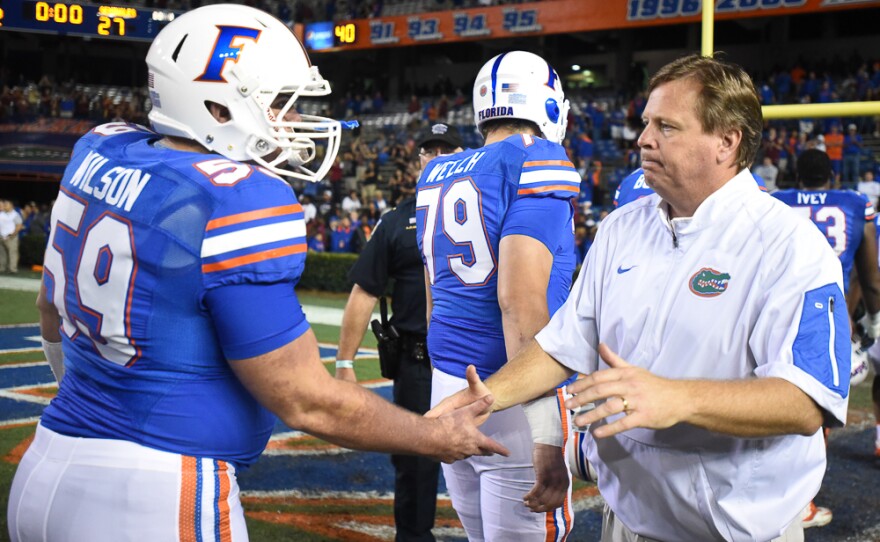 Florida coach Jim McElwain shakes his player's hands after the game on their way to the locker room. Here, Dakota Wilson (59) gets a hand shake from his coach. (Greenberry Taylor/ WUFT News)