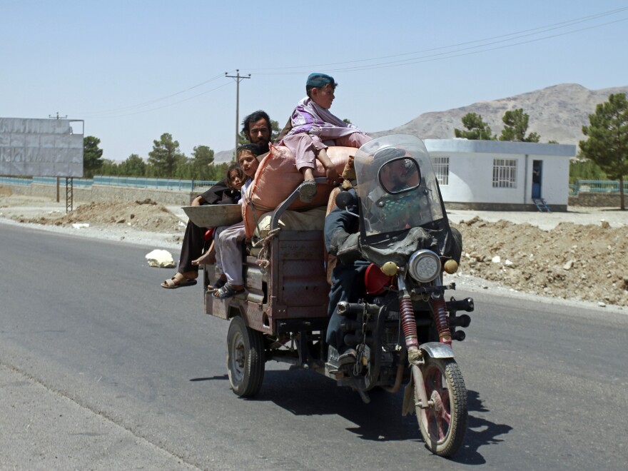 An Afghan family flees fighting as Afghan security personnel took back control of parts of the city of Herat following fighting between Taliban and Afghan security forces, on the outskirts of Herat, 640 kilometers (397 miles) west of Kabul, Afghanistan, on Aug. 8.