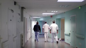 Medical staff of the emergency ward of the Rouvray psychiatric hospital accompany a patient to his room, in France on Nov. 25, 2020. (Thibault Camus/AP)