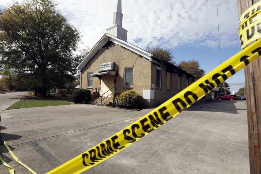 Crime scene tape outlines the perimeter of the Hopewell Missionary Baptist Church in Greenville, Miss., on Tuesday, Nov. 22, 2016, after the church was burned and spray-painted with "Vote Trump," three weeks ago. The First Baptist Church of Greenville has offered congregants of the burned church a new place to worship. (Rogelio V. Solis/AP)