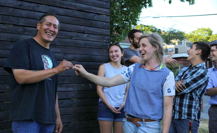 Sarah Smith, of Sawhorse Revolution, hands over the key to Nickelsville resident John Hord.