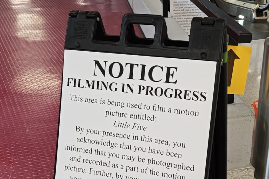 sign reading notice: filming in progress