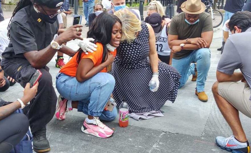 Charlotte Mayor Vi Lyles kneels with protesters June 3, 2020, in uptown.