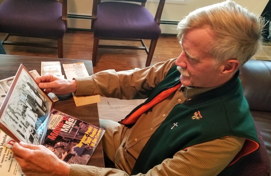 State Rep. Jeff Hanley looks at a family photograph in Nov. 2021. All seven Hanley boys served in the military.