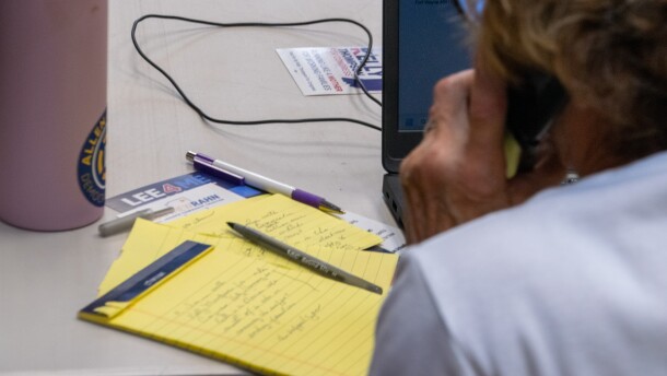 A volunteer reads off her own handwritten notes as she phone banks for candidates out of the Allen County Democratic Party headquarters.