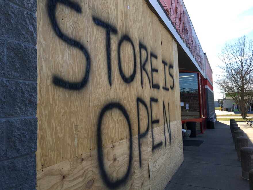 A sign indicates a store is open in flood-damaged Lumberton, N.C. 