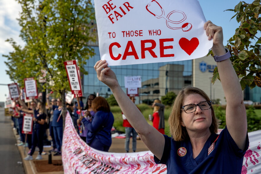 Kylie O’Keefe, an RN in the multidisciplinary clinic, holds a sign on the picket line on Monday, Sept. 25, 2023, outside SM Health St. Louis University Hospital in Midtown St. Louis. Nurses are holding a 24 hour strike, looking for a contract that addresses staffing shortages, increased pay and workplace violence prevention. Nurses gave the hospital advanced notice of the strike to allow for alternative plans to be made for patient care. 