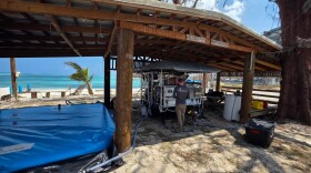 Brent Kejr, water, sanitation and hygiene (WASH) technical adviser and manager of emergency water response for Samaritan's Purse, is testing one of the desalination systems that convert sea water to fresh water at Sugar Dock.