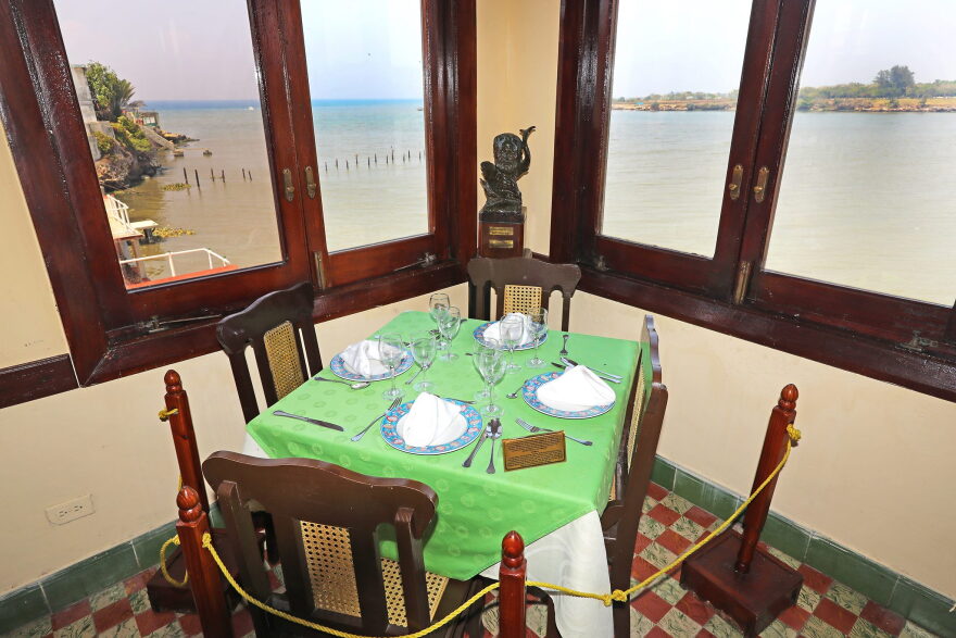 Table in the corner of a restaurant overlooking the ocean.