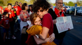 Hollis Moore, a 30-year-old teacher in the Kirkwood School District, hugs their student Maggie McCoy, 10, on Monday, April 17, 2023, before a school board meeting outside North Kirkwood Middle School in Kirkwood. Moore alleges they have been discriminated against by district officials due to their gender identity.