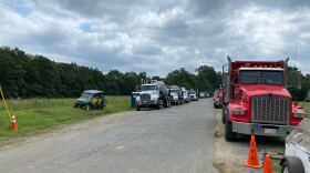 Dozens of heavy duty and pickup trucks line the sides of an off-road near Huntersville-Concord Road on Thursday August 20th. Colonial Pipeline said it had completed a repair of the leak by that evening.