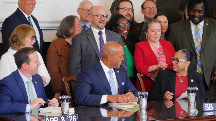From left to right: Senate President Bill Ferguson, Gov. Wes Moore and House Speaker Joseline Peña-Melnyk sign the three-bill fiscal year 2027 budget package on Wednesday in the Governor's Reception Room in Annapolis, Md.