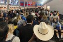 People wait in line to go through customs at Dallas/Fort Worth International Airport on Saturday. International travelers reported long customs lines at the airport Saturday as staff took extra precautions to guard against the new coronavirus.