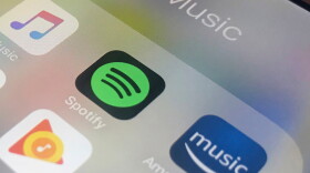 Icons of music streaming platforms on a phone screen.