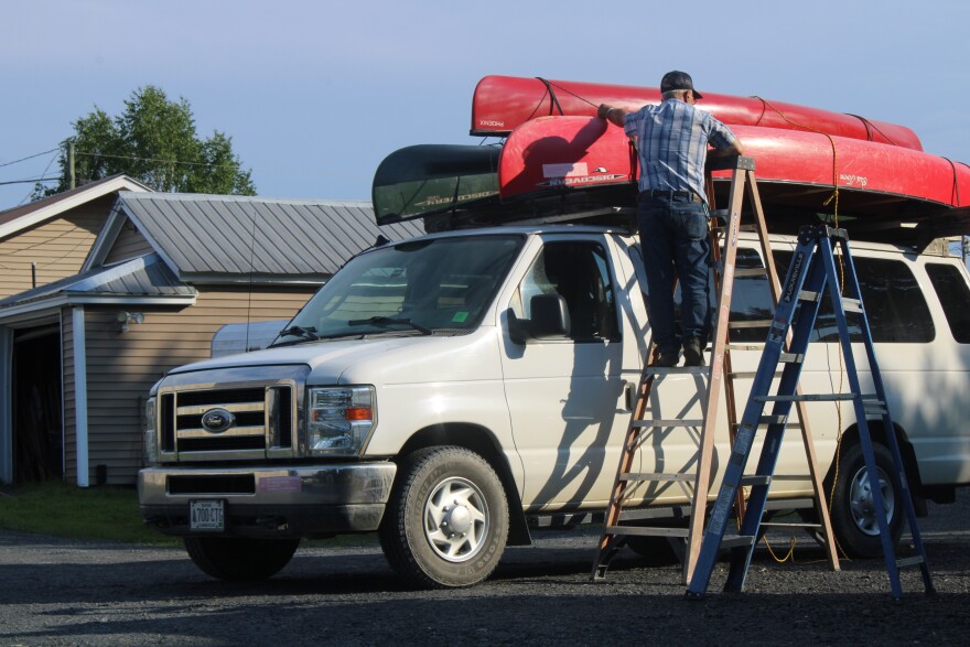 Norm L'Italien securing canoes to one of his transport vans on Sunday, June 28th, 2026.