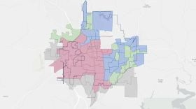 The areas in red represent inactive construction areas. The areas in blue and green represent completed fiber installs and completed projects, respectively. Grey areas represent planning and design sections.