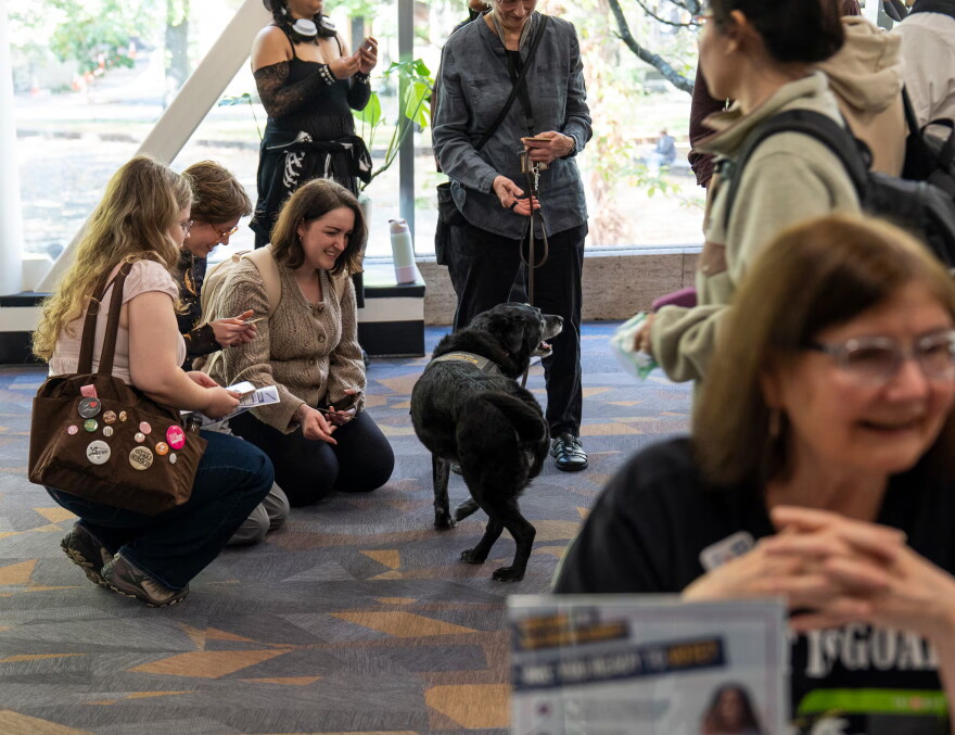Students interact with service dogs near the voter registration tables at Portland State University on Oct. 6, 2026.