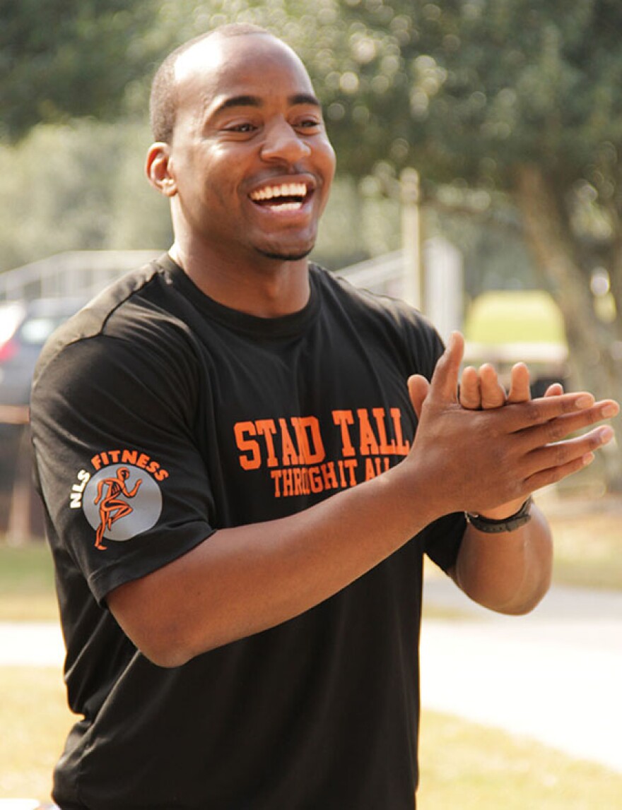 Former UF football player Zephrin Augustine Jr. (known as “Coach Zep”), gives the runners a round of applause during the closing ceremony of the Next Level Sports and Fitness 5k run and obstacle course. (Photo by Neosman Flores/WUFT News)