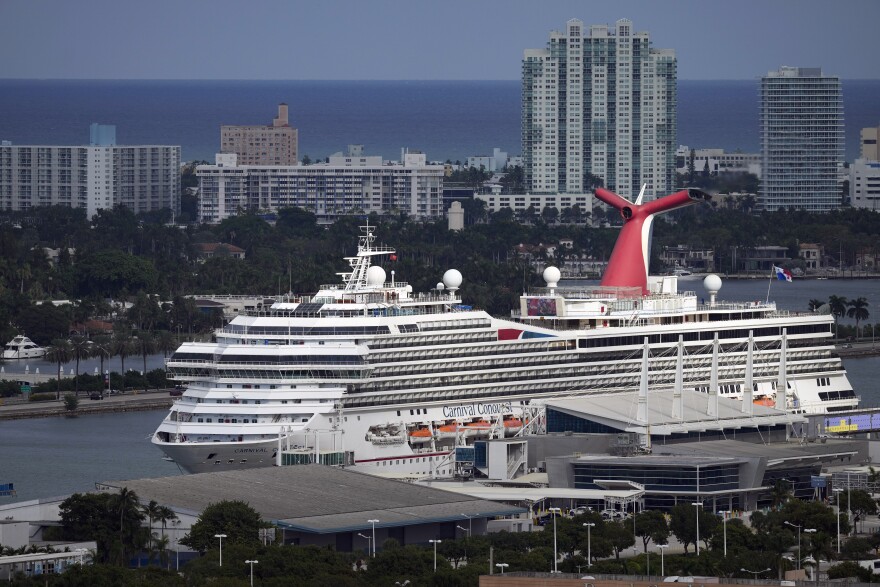 FILE - The Carnival Conquest cruise ship sits docked at port on Oct. 20, 2021, in Miami. Long-battered shares of Carnival Corp. jumped more than 12% Friday, June 24, 2022, as the cruise line owner reported a big increase in revenue, occupancy levels, and bookings for future trips. However, the company posted a $1.83 billion second-quarter loss and said the effects of the pandemic and higher fuel prices will lead to another loss in the third quarter. (AP Photo/Rebecca Blackwell, File)