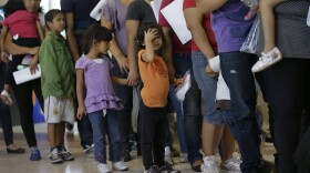 Immigrants who entered the U.S. illegally stand in line for bus tickets after their release in June from a U.S. Customs and Border Protection processing facility in McAllen, Texas.