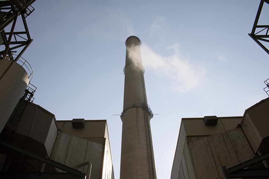 Steam passes in front the stack for PSO Northeast Station's coal-fired units, both of which will be retired by 2026. 