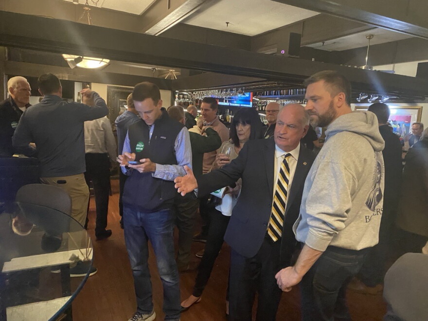 Bloomington mayoral candidate Dan Brady, second from right, watches the results come in Tuesday night at Jim's Steakhouse.