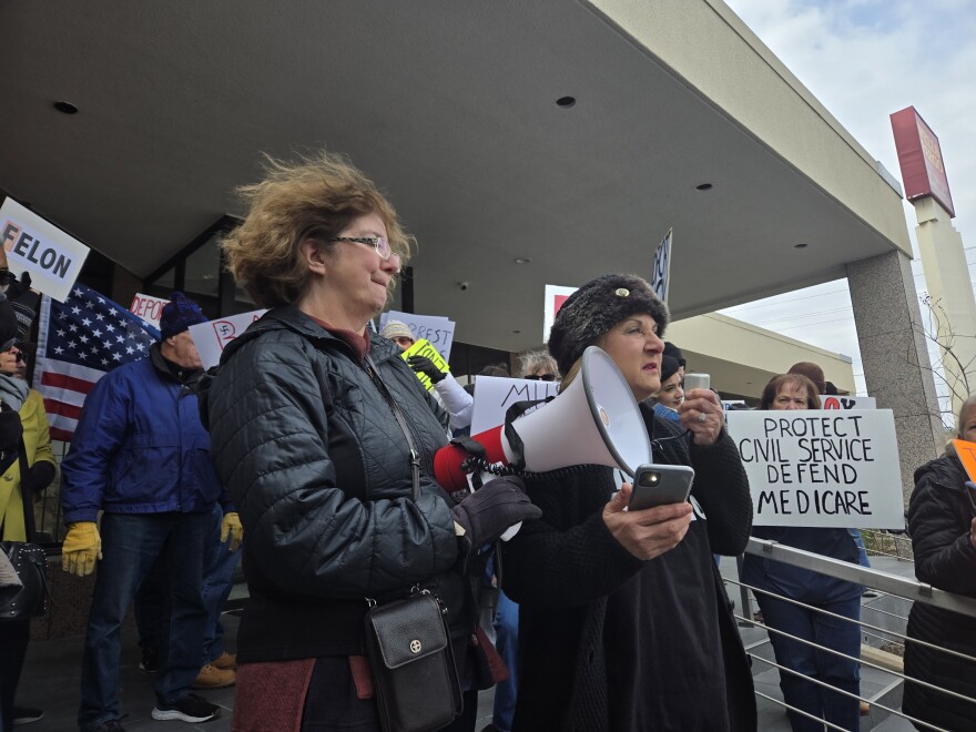 Bexar County Democratic Party Chair Michelle Lowe Solis, left, and Marinella Murrillo, executive vice president of District 6 AFL-CIO, right, kickoff the protest using a bullhorn on Feb. 13, 2025