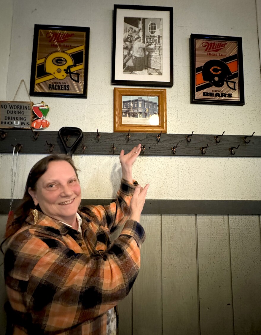 April Minniear, bartender at Hansen's Tap in Racine, showing off the rivalry wall