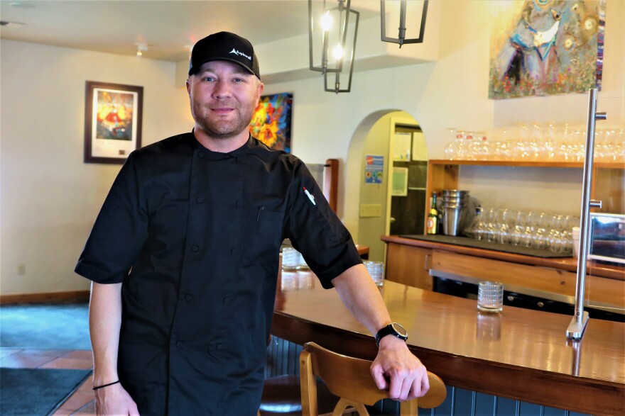 Tyler Samson purchased Bistro Enzo from James Honaker and reopened in May 2020. The restaurant has been refreshed with paintings by Kira Fercho and the addition of new bar seating and a chef’s counter.