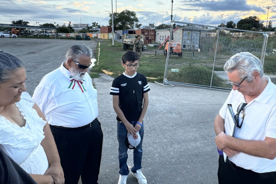 Pastor Javier Leyva (right) leads a prayer vigil near the Rio Grande in Eagle Pass, Texas. The participants memorialized migrants and the members of the Texas National Guard who have died on the border.