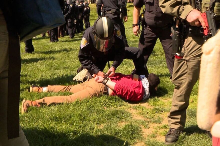 A protester arrested by state police in Dunn Meadow, April 2024.