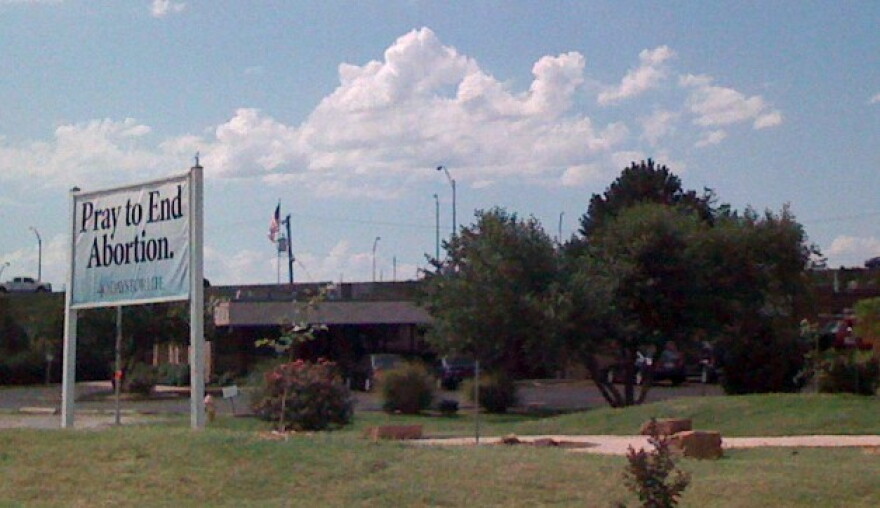 A pro-life sign across the street from Tulsa's Reproductive Services. Reproductive Services is challenging the state law.