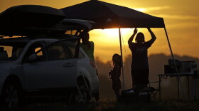 A family sets up a tent at their campsite at sunrise for the solar eclipse Monday, Aug. 21, 2017, on the Orchard Dale historical farm near Hopkinsville, Ky. The location, which is in the path of totality, is also at the point of greatest intensity. (Mark Humphrey/AP)